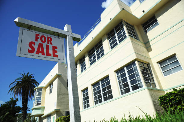 Blank Real Estate Agent Sign with Art Deco Apartment Building Cheap houses for sale in Miami Florida under $50,000 fixer-upper property